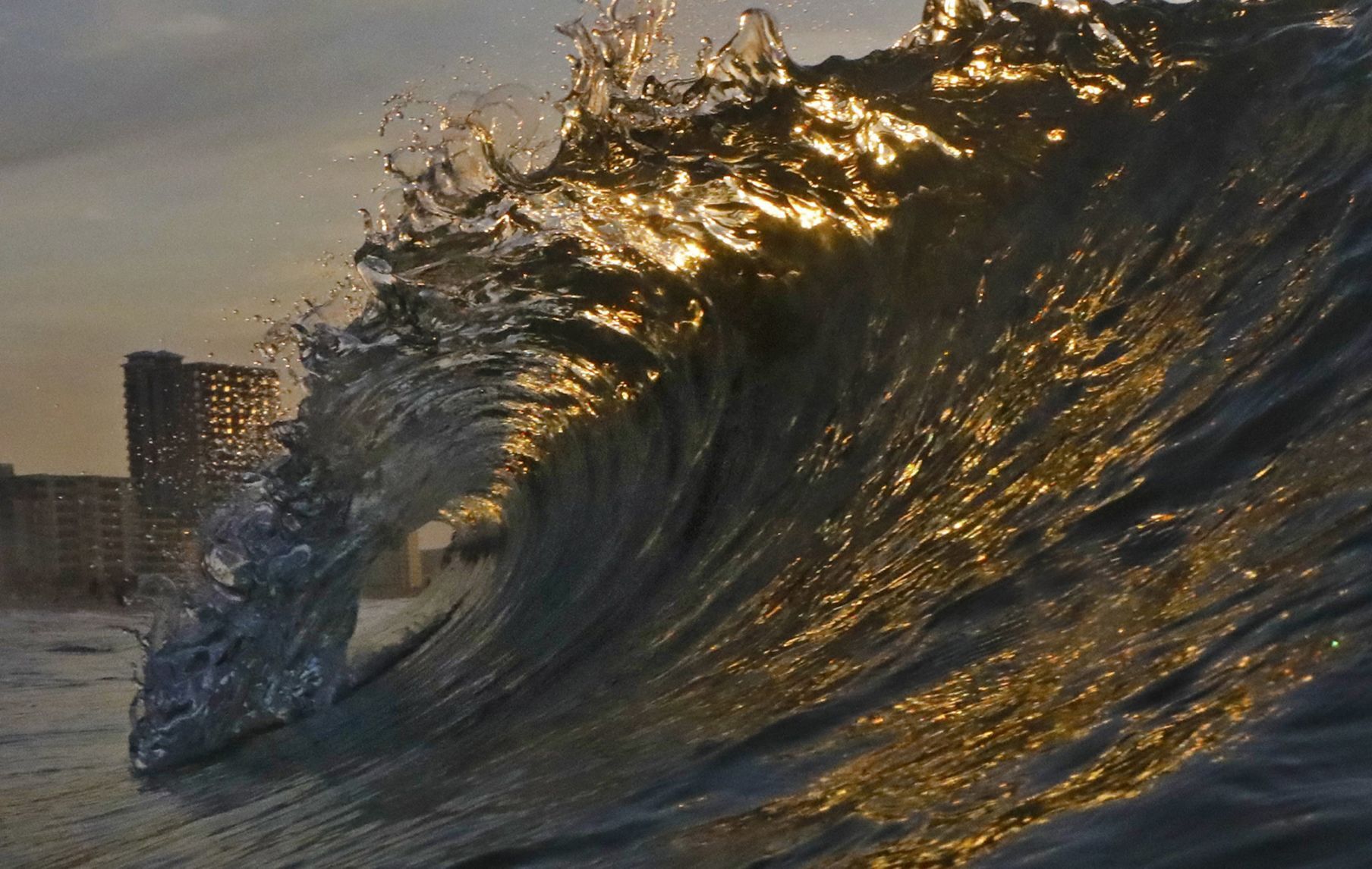 Golden waves at dawn roll on Gulf Shores